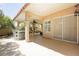 Entertainers back patio featuring outdoor dining, ceiling fan, and lush landscaping for a peaceful, private retreat at 8875 Tidal Bay Dr, Las Vegas, NV 89117