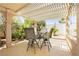 Charming outdoor dining area on a covered patio, perfect for entertaining with lush greenery and serene ambiance at 8875 Tidal Bay Dr, Las Vegas, NV 89117