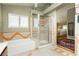 Bathroom with decorative tile accents, separate tub and shower, with a view of bedroom at 8875 Tidal Bay Dr, Las Vegas, NV 89117