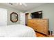 Bedroom featuring hardwood floors, a dresser, and a TV mounted on the wall at 8875 Tidal Bay Dr, Las Vegas, NV 89117