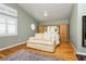 Spacious bedroom with hardwood floors, vaulted ceiling, and a stylish sitting area at 8875 Tidal Bay Dr, Las Vegas, NV 89117