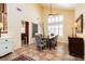 Elegant dining room with large windows, high ceilings, stylish furniture, and tiled floors at 8875 Tidal Bay Dr, Las Vegas, NV 89117