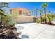 Charming two-story home featuring a three-car garage, well-manicured landscaping, and palm trees at 8875 Tidal Bay Dr, Las Vegas, NV 89117