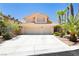 Charming two-story home with a two-car garage, desert landscaping, and a tile roof at 8875 Tidal Bay Dr, Las Vegas, NV 89117