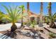 Charming home with desert landscaping featuring palm trees, rocks, and a well maintained front yard at 8875 Tidal Bay Dr, Las Vegas, NV 89117