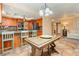 Open kitchen layout with tile floors, oak cabinetry, stainless appliances, and adjacent living area at 8875 Tidal Bay Dr, Las Vegas, NV 89117