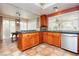 Well-equipped kitchen with oak cabinets, stainless appliances, and natural light from windows and sliding door at 8875 Tidal Bay Dr, Las Vegas, NV 89117
