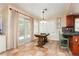Charming kitchen with tile flooring, oak cabinets, and sliding door access to the backyard at 8875 Tidal Bay Dr, Las Vegas, NV 89117