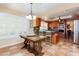 Spacious kitchen featuring oak cabinetry, stainless steel appliances, and a stylish breakfast nook table at 8875 Tidal Bay Dr, Las Vegas, NV 89117