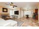 Open-concept living area with tiled floors, fireplace, and bar seating area at 8875 Tidal Bay Dr, Las Vegas, NV 89117