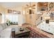 Inviting living room with tiled floors, staircase, and stylish decor and furnishings at 8875 Tidal Bay Dr, Las Vegas, NV 89117