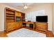 Home office with custom built-ins, desk, and hardwood floors at 8875 Tidal Bay Dr, Las Vegas, NV 89117