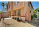 This backyard has minimal landscaping with stucco walls and desert landscaping at 9115 Canoga Canyon Ct # 103, Las Vegas, NV 89149