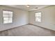 Spacious bedroom with neutral carpet, dual windows, and natural light at 9115 Canoga Canyon Ct # 103, Las Vegas, NV 89149
