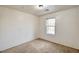 This bedroom has neutral carpet and a window that allows for ample natural light at 9115 Canoga Canyon Ct # 103, Las Vegas, NV 89149
