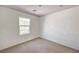 This bedroom has neutral carpet and a window that allows for ample natural light at 9115 Canoga Canyon Ct # 103, Las Vegas, NV 89149