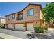 Exterior view of a beautiful townhouse with a small balcony and three garage doors at 9115 Canoga Canyon Ct # 103, Las Vegas, NV 89149