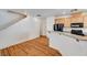 An open concept kitchen with light wooden cabinetry and a granite topped breakfast bar at 9115 Canoga Canyon Ct # 103, Las Vegas, NV 89149