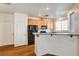 A well-lit kitchen with light colored cabinets, recessed lights and granite countertops at 9115 Canoga Canyon Ct # 103, Las Vegas, NV 89149