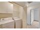 Laundry room featuring white appliances, storage and access to hallway at 9115 Canoga Canyon Ct # 103, Las Vegas, NV 89149