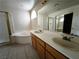 Bathroom with double sink vanity, garden tub, and separate shower with glass enclosure at 9693 Bighorn Island Ave, Las Vegas, NV 89148