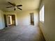 Bright bedroom featuring neutral carpet, ceiling fan, a window, and multiple entryways at 9693 Bighorn Island Ave, Las Vegas, NV 89148