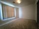 Bright carpeted bedroom with a window, light-colored walls, and a closet at 9693 Bighorn Island Ave, Las Vegas, NV 89148