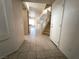 Hallway featuring tile flooring, access to the upper level, and open access to kitchen at 9693 Bighorn Island Ave, Las Vegas, NV 89148