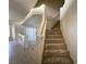 Carpeted staircase with white railing leading to the upper level of the home, adjacent to a tile floor living area at 9693 Bighorn Island Ave, Las Vegas, NV 89148