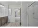 Bathroom with double sink, vanity, and walk-in shower with glass door at 9784 Kodiak Island Ct, Las Vegas, NV 89141