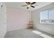 Bedroom with a chair and desk, neutral walls and carpet, and a ceiling fan at 9784 Kodiak Island Ct, Las Vegas, NV 89141