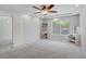 Cozy bedroom with a ceiling fan, bright window, and neutral carpet at 9784 Kodiak Island Ct, Las Vegas, NV 89141