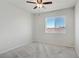 Empty bedroom features neutral colored walls, carpet, and window with view of the neighborhood at 9784 Kodiak Island Ct, Las Vegas, NV 89141