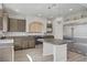 Spacious kitchen featuring stainless steel appliances, granite counters, and light wood-look flooring at 9784 Kodiak Island Ct, Las Vegas, NV 89141