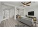 Bright living room with modern gray tones, hardwood floors, and stylish ceiling fan at 9784 Kodiak Island Ct, Las Vegas, NV 89141