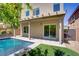 Backyard pool with a waterfall feature, a covered patio, and a sliding glass door to the house at 9784 Kodiak Island Ct, Las Vegas, NV 89141
