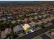 Aerial view of a residential neighborhood showcasing a well-maintained home with a landscaped yard and desert surroundings at 9909 Masked Duck Ave, Las Vegas, NV 89117