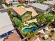 Aerial view of a home with a backyard featuring a sparkling pool, spa, outdoor living and lush landscaping at 9909 Masked Duck Ave, Las Vegas, NV 89117
