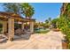 Inviting backyard with a covered patio and a luxurious pool with a waterfall feature at 9909 Masked Duck Ave, Las Vegas, NV 89117