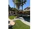 Backyard featuring a pool, spa, covered outdoor living space, and lush landscaping, perfect for entertaining at 9909 Masked Duck Ave, Las Vegas, NV 89117