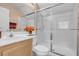 Well-lit bathroom featuring a glass-enclosed shower and modern fixtures at 9909 Masked Duck Ave, Las Vegas, NV 89117
