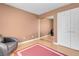 Cozy bedroom features closet with mirrored doors and a comfortable seating area at 9909 Masked Duck Ave, Las Vegas, NV 89117
