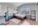 Comfortable bedroom featuring a bed, large window, and hardwood floors, perfect for relaxing at 9909 Masked Duck Ave, Las Vegas, NV 89117