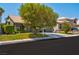 Inviting single-Gathering home with lush front lawn, mature tree, and convenient two-car garage at 9909 Masked Duck Ave, Las Vegas, NV 89117