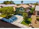 Inviting two-story home with well-manicured lawn, mature trees, and a spacious driveway at 9909 Masked Duck Ave, Las Vegas, NV 89117