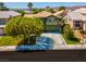 Inviting two-story home with well-manicured lawn, mature trees, and a spacious driveway at 9909 Masked Duck Ave, Las Vegas, NV 89117