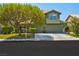 Charming two-story home featuring a spacious driveway, mature landscaping, and a well-maintained lawn at 9909 Masked Duck Ave, Las Vegas, NV 89117
