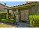 Welcoming front porch with decorative security door, charming potted plants, and well-maintained landscaping at 9909 Masked Duck Ave, Las Vegas, NV 89117