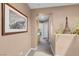 Hallway with decorative plants and artwork leading to other rooms at 9909 Masked Duck Ave, Las Vegas, NV 89117