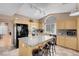 Well-lit kitchen showcasing a granite island, modern appliances, and natural wood cabinets at 9909 Masked Duck Ave, Las Vegas, NV 89117